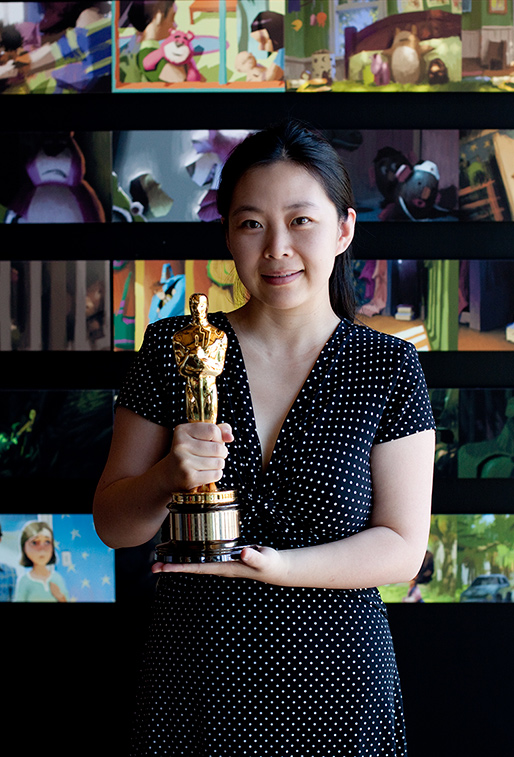 Lan Tang holding the Academy Award for Toy Story 3 at Pixar Animation Studios